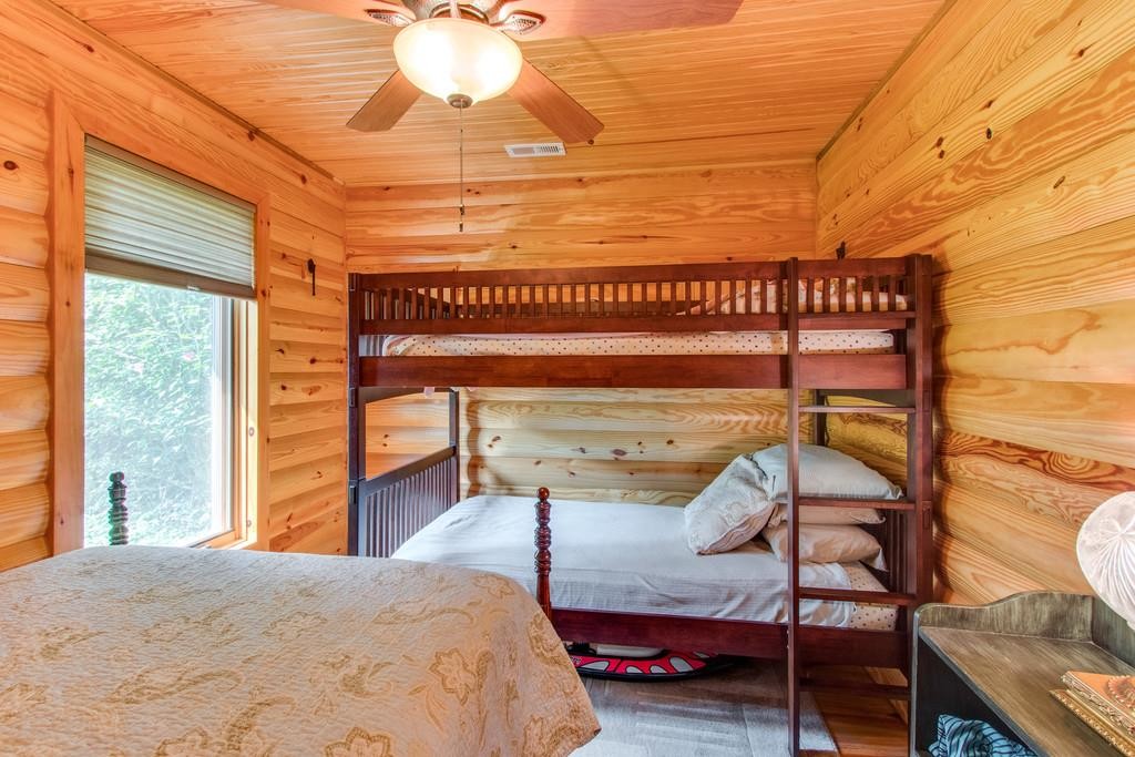 320 Captain Point Silver Point, TN 38582 - Photo 18 of 23 a bedroom with a bed and a chandelier