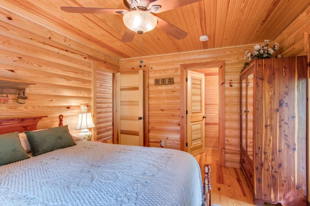 320 Captain Point Silver Point, TN 38582 - Photo 20 of 23 a bedroom with a bed and a chandelier