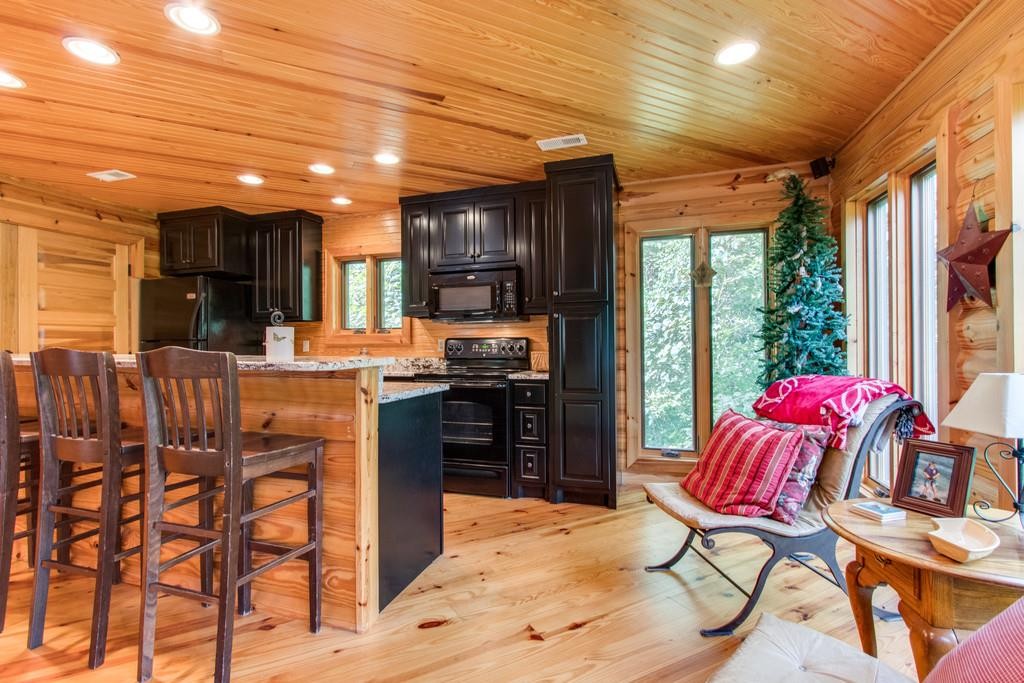 320 Captain Point Silver Point, TN 38582 - Photo 8 of 23 a kitchen with stainless steel appliances kitchen island granite countertop a refrigerator and a stove top oven