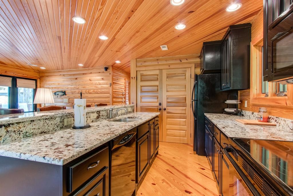 320 Captain Point Silver Point, TN 38582 - Photo 9 of 23 a kitchen with stainless steel appliances granite countertop a sink stove and cabinets