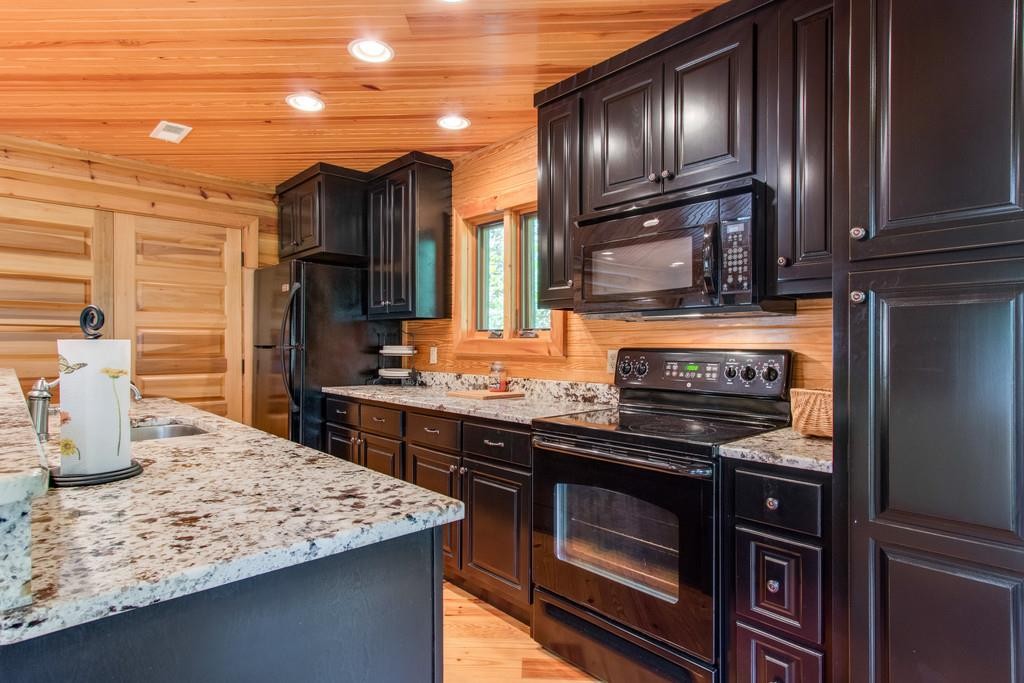 320 Captain Point Silver Point, TN 38582 - Photo 10 of 23 a kitchen with kitchen island granite countertop wooden cabinets and stainless steel appliances