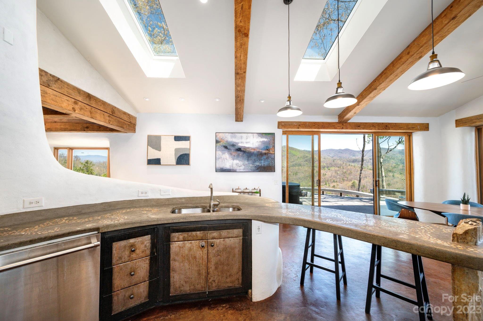 5013 Needmore Road Bryson City, NC 28713 - Photo 11 of 48 a dining hall with stainless steel appliances granite countertop a sink and a large window