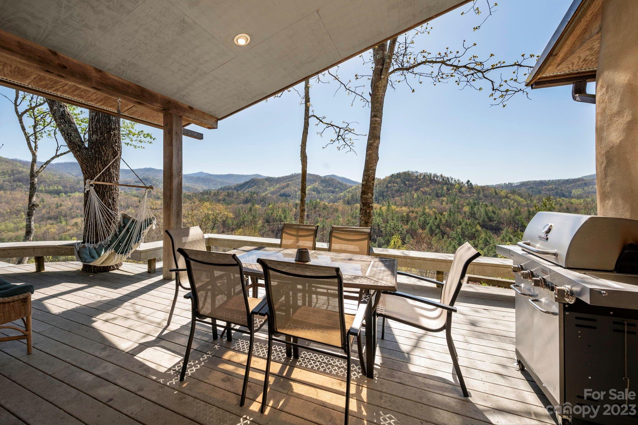 5013 Needmore Road Bryson City, NC 28713 - Photo 14 of 48 a view of a balcony with chairs and wooden floor