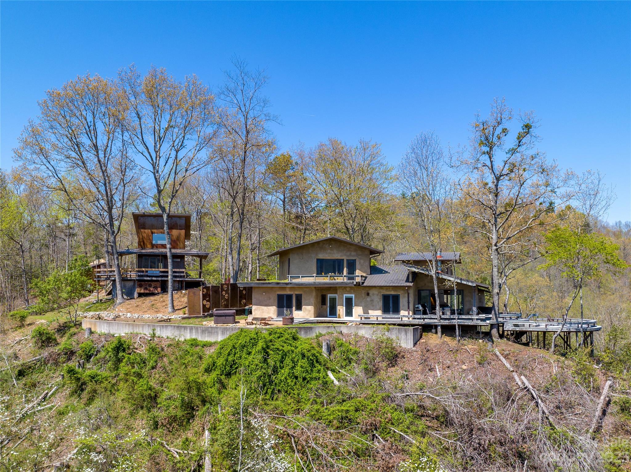 5013 Needmore Road Bryson City, NC 28713 - Photo 2 of 48 a front view of a house with swimming pool and sitting area