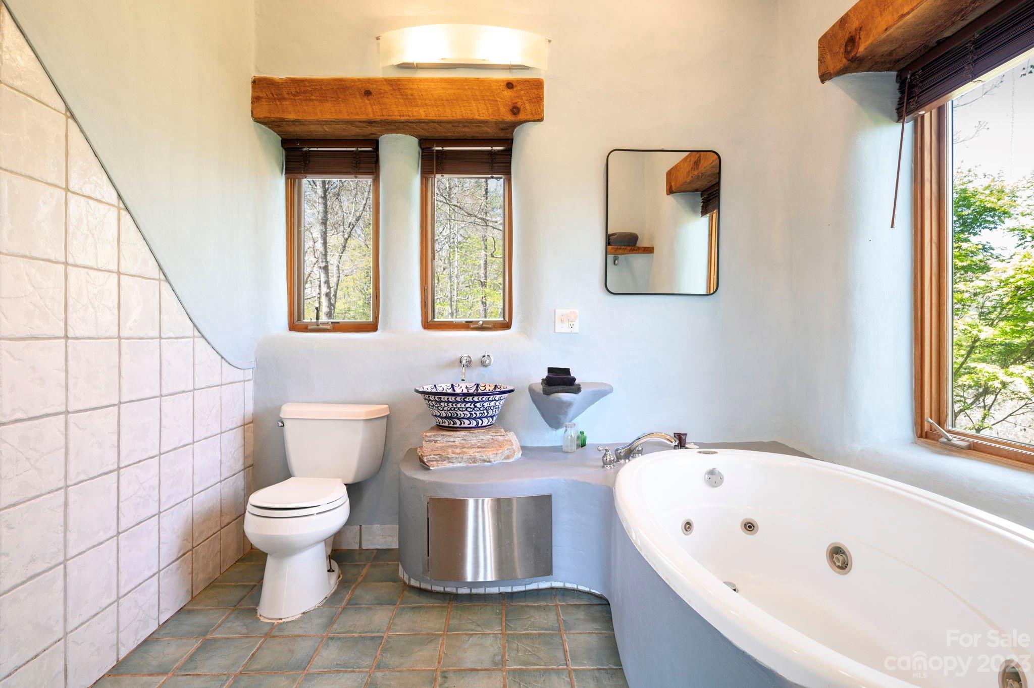 5013 Needmore Road Bryson City, NC 28713 - Photo 22 of 48 a bathroom with a sink a toilet and bathtub