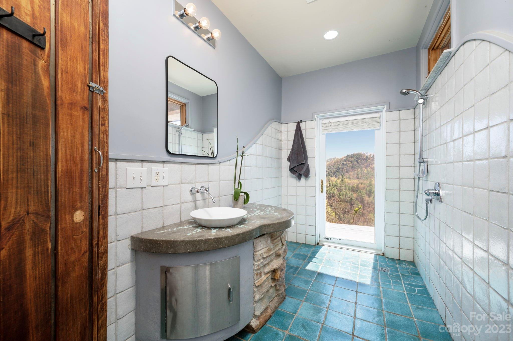 5013 Needmore Road Bryson City, NC 28713 - Photo 25 of 48 a bathroom with a sink and a mirror