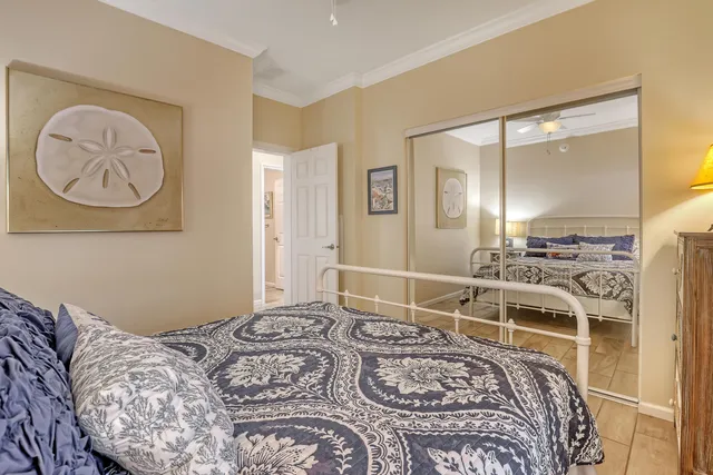 a bedroom with a large bed and a chandelier