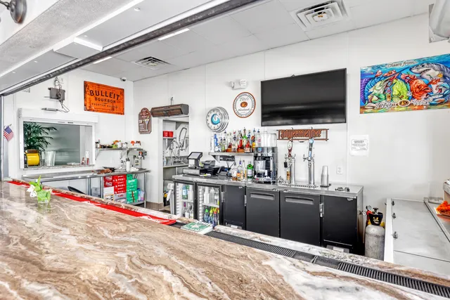 a room with pool table and windows
