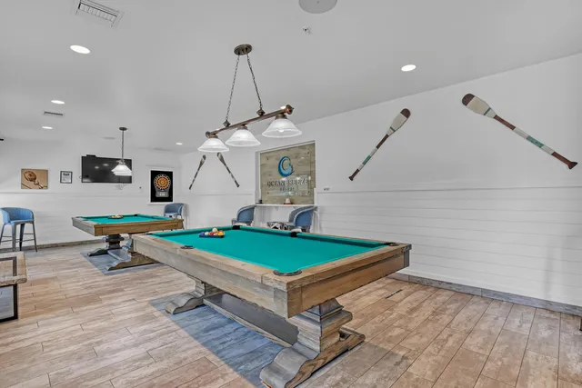 a view of a swimming pool with a table and chairs under an umbrella