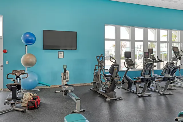 a view of a workspace with furniture and a flat screen tv