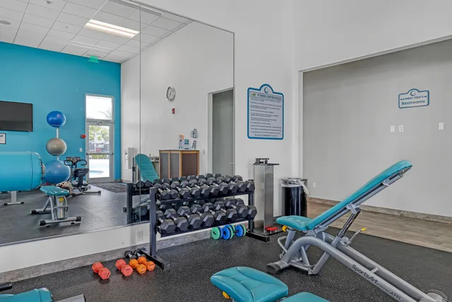 a room with gym equipment and windows
