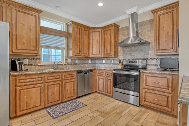 a kitchen with stainless steel appliances granite countertop a sink stove and cabinets