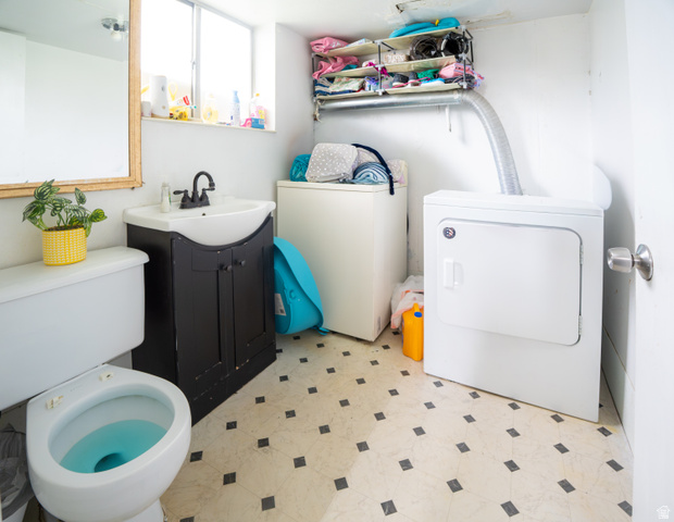 1347 South 400 East Springville, UT 84663 - Photo 18 of 20 Compact utility space featuring a white toilet, black vanity with an integrated sink, and patterned floor tiles