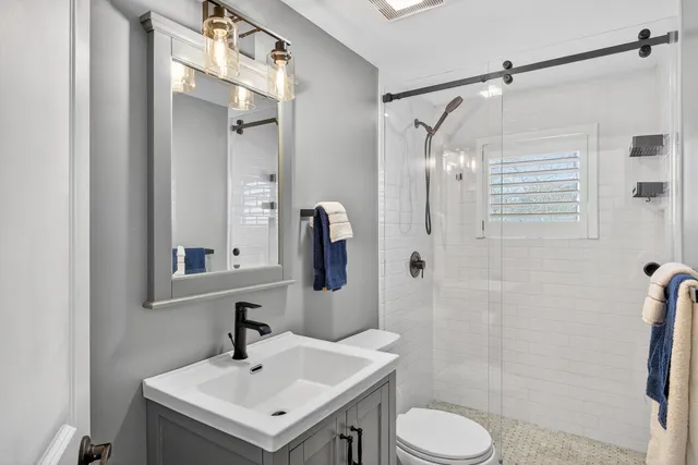a bathroom with a sink toilet and shower