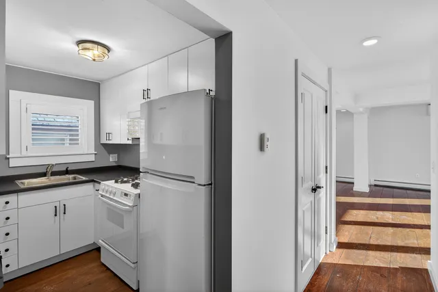 a white refrigerator freezer sitting inside of a kitchen
