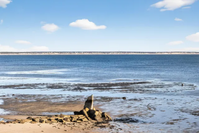 a view of a large building with a big yard and large trees