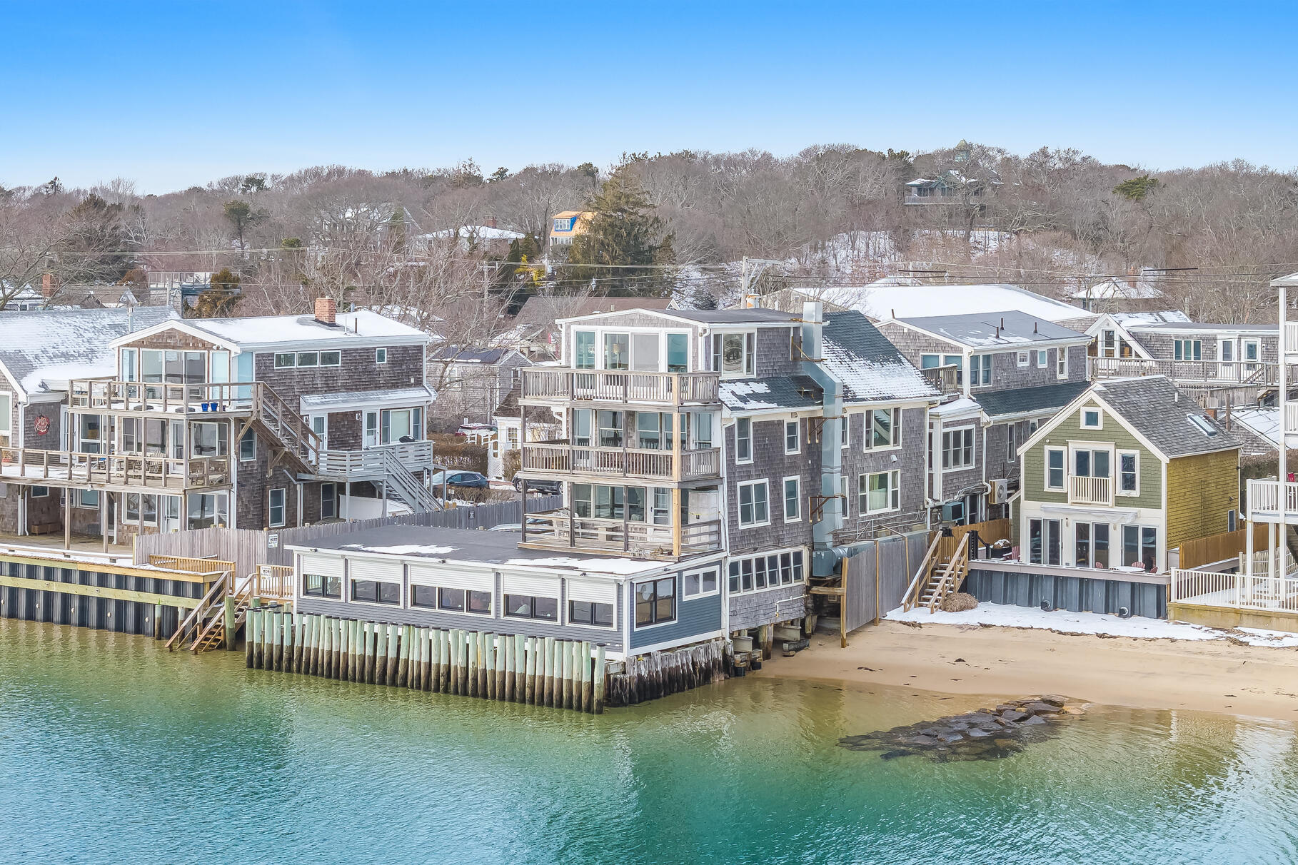 539 Commercial Street, Unit 3 Provincetown, MA 02657 - Photo 26 of 29 a view of a large building with a big yard and large trees