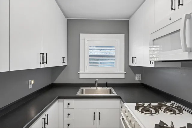 a kitchen with a sink stove and cabinets