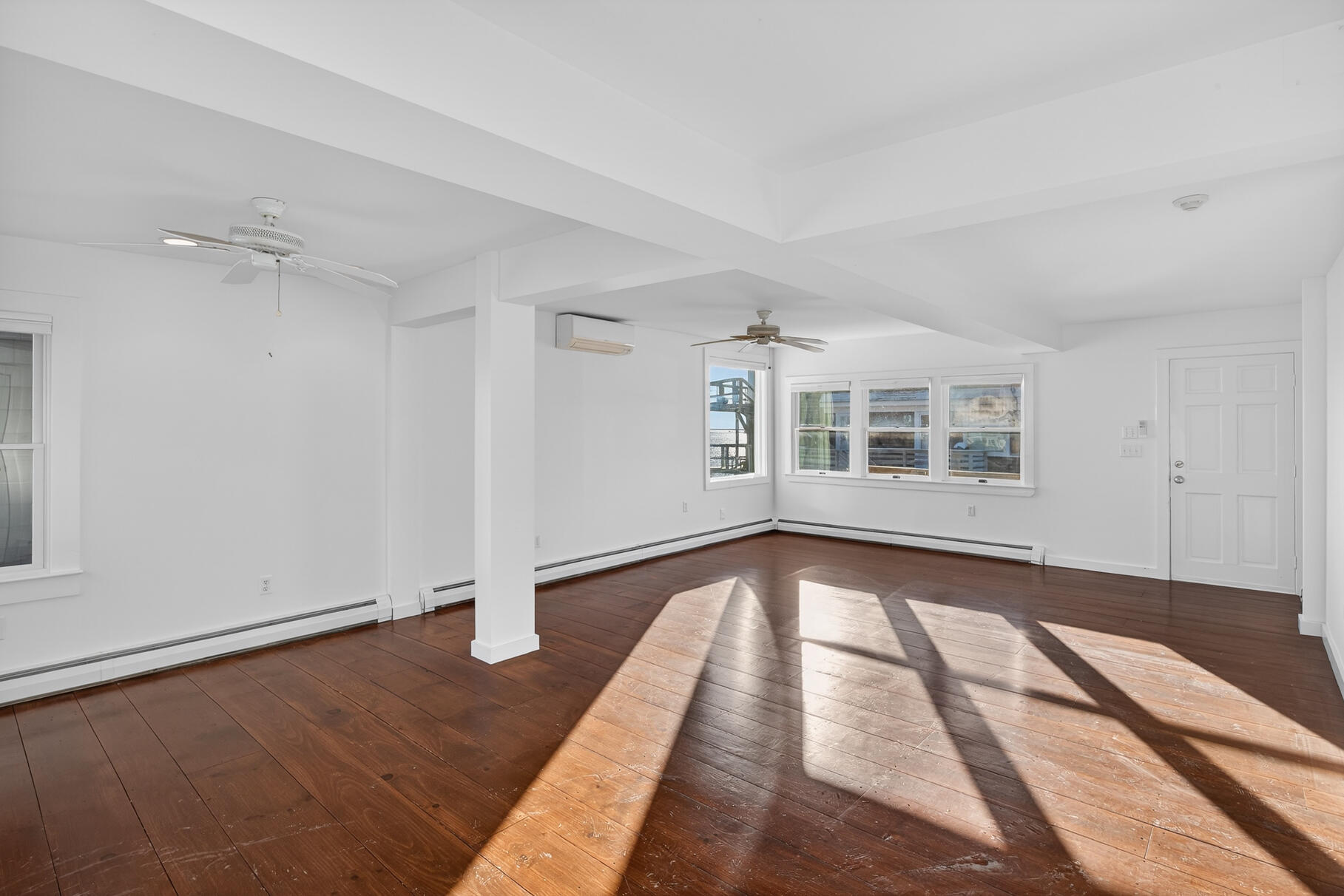 539 Commercial Street, Unit 3 Provincetown, MA 02657 - Photo 10 of 29 a view of an empty room with wooden floor and a window