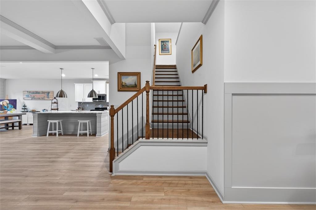 311 Rockwell Church Road Northwest Winder, GA 30680 - Photo 19 of 55 a view of staircase and living room with wooden floor