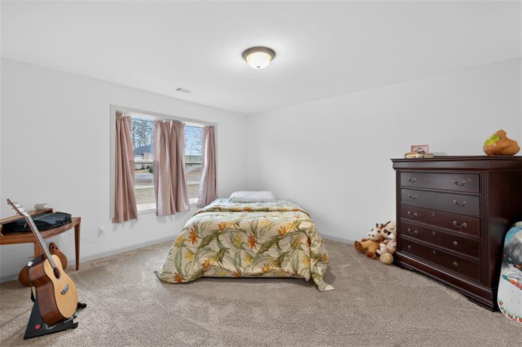 311 Rockwell Church Road Northwest Winder, GA 30680 - Photo 26 of 55 a bedroom with a bed and a window