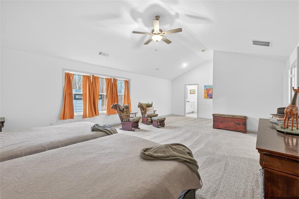 311 Rockwell Church Road Northwest Winder, GA 30680 - Photo 32 of 55 a bedroom with furniture and a large window