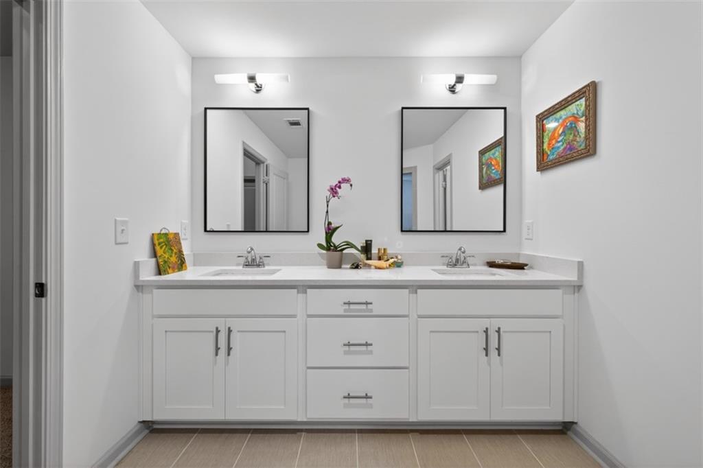 311 Rockwell Church Road Northwest Winder, GA 30680 - Photo 36 of 55 a bathroom with double vanity sinks and a mirror