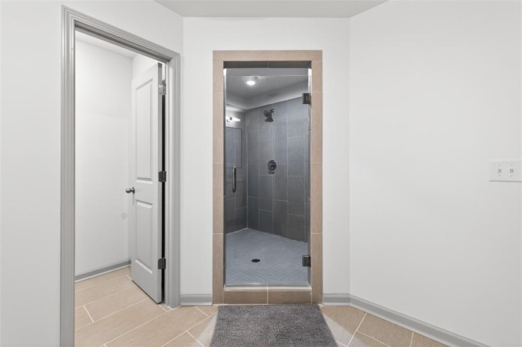 311 Rockwell Church Road Northwest Winder, GA 30680 - Photo 38 of 55 a bathroom with a glass shower door