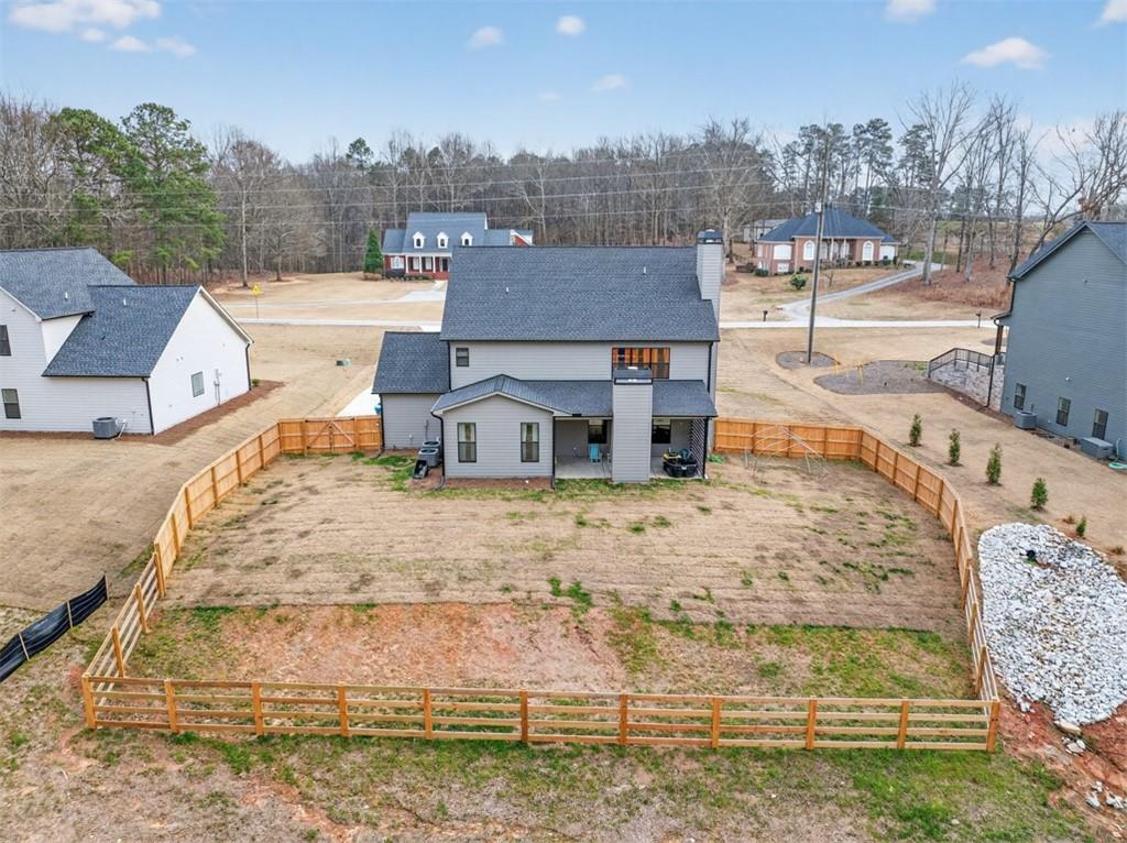 311 Rockwell Church Road Northwest Winder, GA 30680 - Photo 51 of 55 a view of a house with a yard and trees in the background