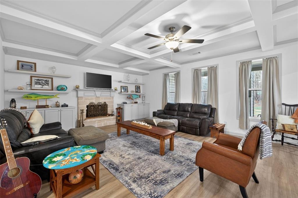 311 Rockwell Church Road Northwest Winder, GA 30680 - Photo 6 of 55 a living room with furniture a fireplace and a flat screen tv