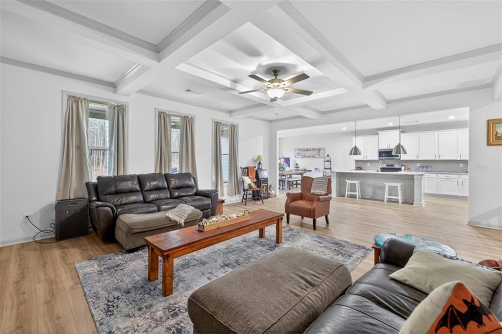 311 Rockwell Church Road Northwest Winder, GA 30680 - Photo 8 of 55 a living room with furniture and a chandelier