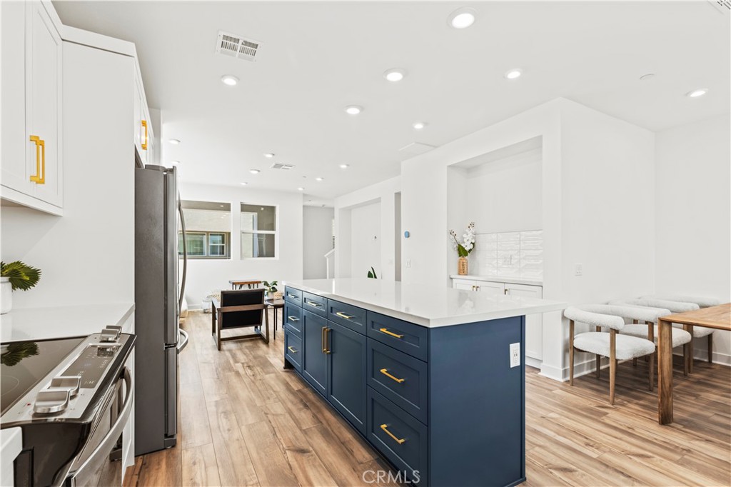 609 South Lyon Street Santa Ana, CA 92705 - Photo 13 of 36 a kitchen with stainless steel appliances granite countertop a stove and a wooden floors