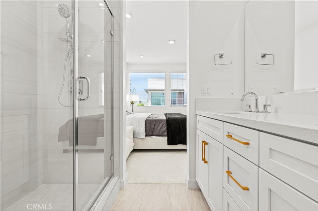 609 South Lyon Street Santa Ana, CA 92705 - Photo 19 of 36 a en suite bathroom with a double vanity sink a mirror and a shower