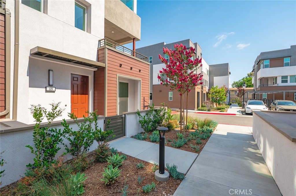 609 South Lyon Street Santa Ana, CA 92705 - Photo 2 of 36 a front view of a building with flowers