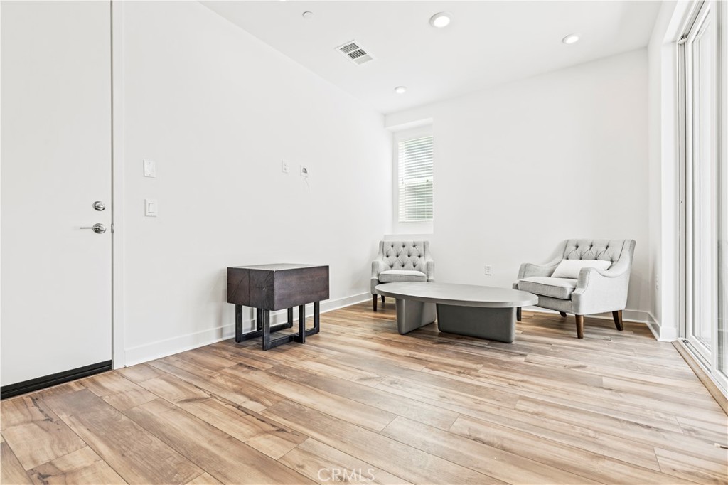 609 South Lyon Street Santa Ana, CA 92705 - Photo 3 of 36 a spacious bedroom with a bed and a table in it
