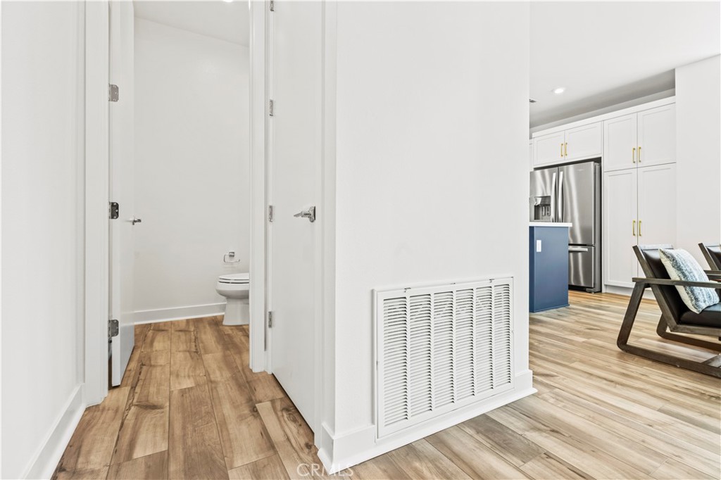609 South Lyon Street Santa Ana, CA 92705 - Photo 5 of 36 a view of a hallway with wooden floor and furniture