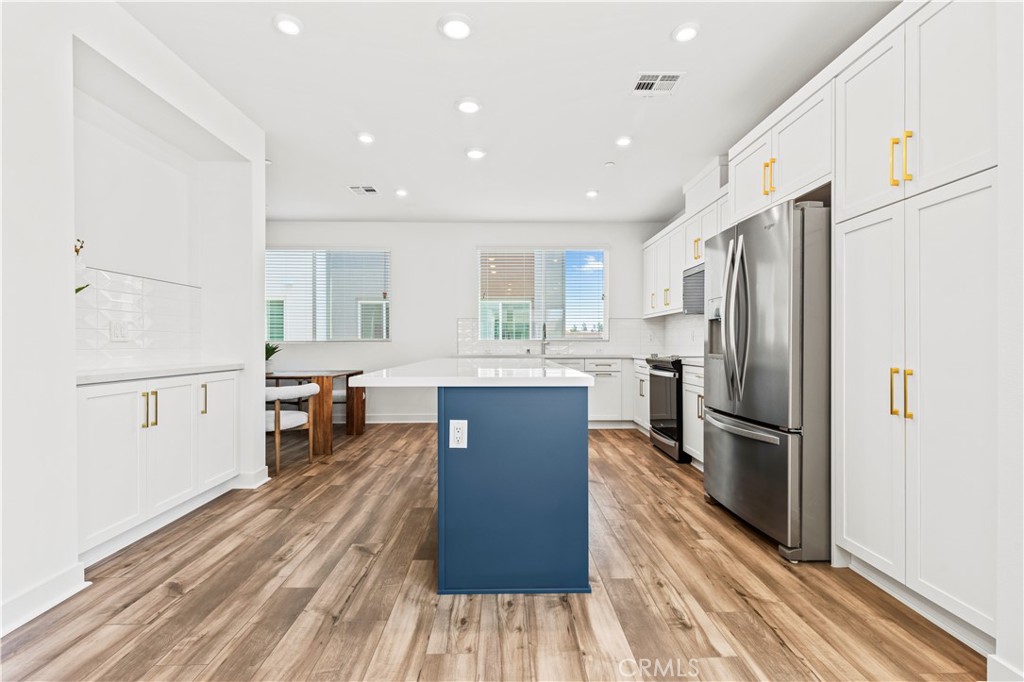 609 South Lyon Street Santa Ana, CA 92705 - Photo 10 of 36 a large kitchen with stainless steel appliances a refrigerator and a stove top oven