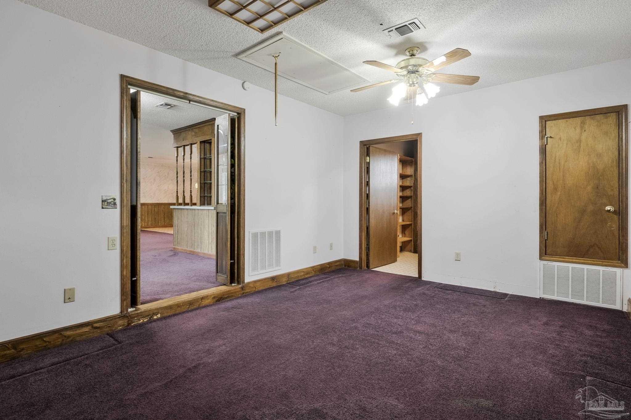4411 Pace Lane Pace, FL 32571 - Photo 60 of 68 an empty room with closet and a chandelier fan