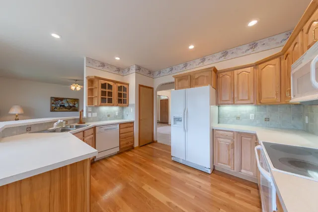 a kitchen with stainless steel appliances granite countertop a refrigerator and a sink