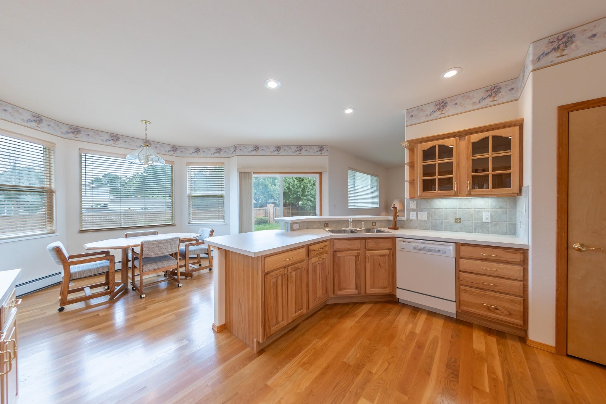 2802 Grand View Circle Grand Junction, CO 81506 - Photo 14 of 21 a kitchen with stainless steel appliances granite countertop wooden floors and white cabinets