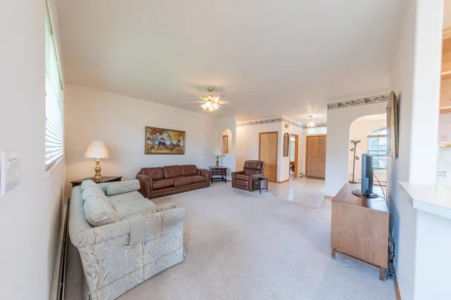 a bedroom with furniture and a large mirror