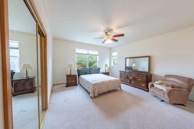 a spacious bedroom with a bed and a couch