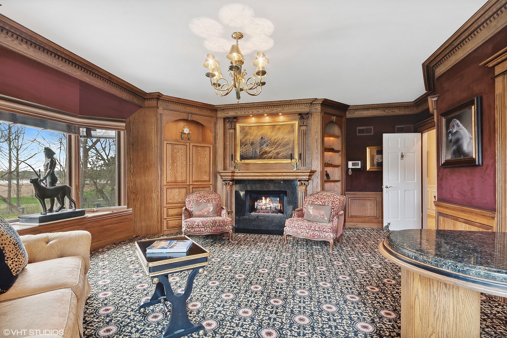 211 Otis Road Barrington Hills, IL 60010 - Photo 22 of 68 a living room with furniture a fireplace and a chandelier