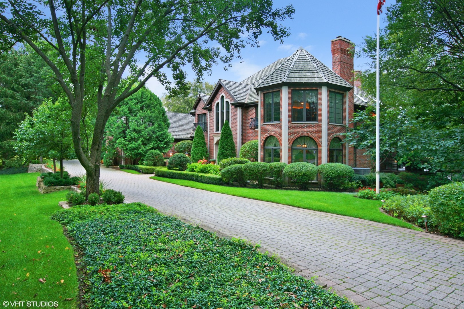 211 Otis Road Barrington Hills, IL 60010 - Photo 4 of 68 a view of a brick house with a yard and plants
