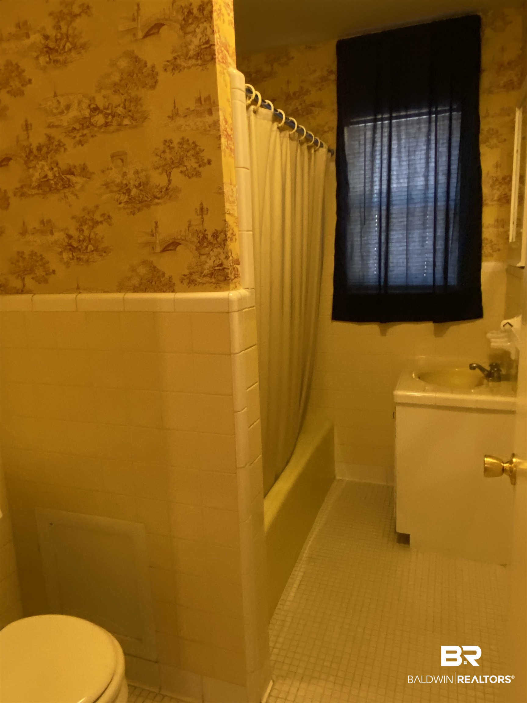 106 Terry Drive Brewton, AL 36426 - Photo 16 of 25 Full bathroom featuring tile walls, wallpapered walls, shower / tub combo, vanity, and wainscoting