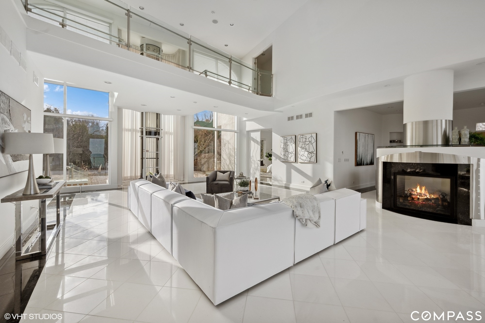 25 Aspen Lane Glencoe, IL 60022 - Photo 8 of 47 a living room with furniture a fireplace and a large window