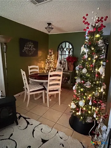 a dining room with furniture and chandelier kitchen view