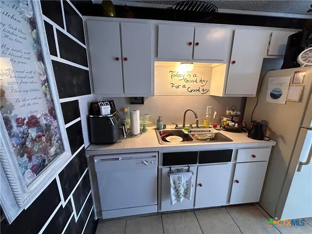 a utility room with cabinets washer and dryer