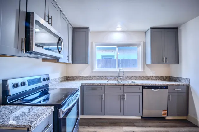 a kitchen with cabinets appliances and a counter top