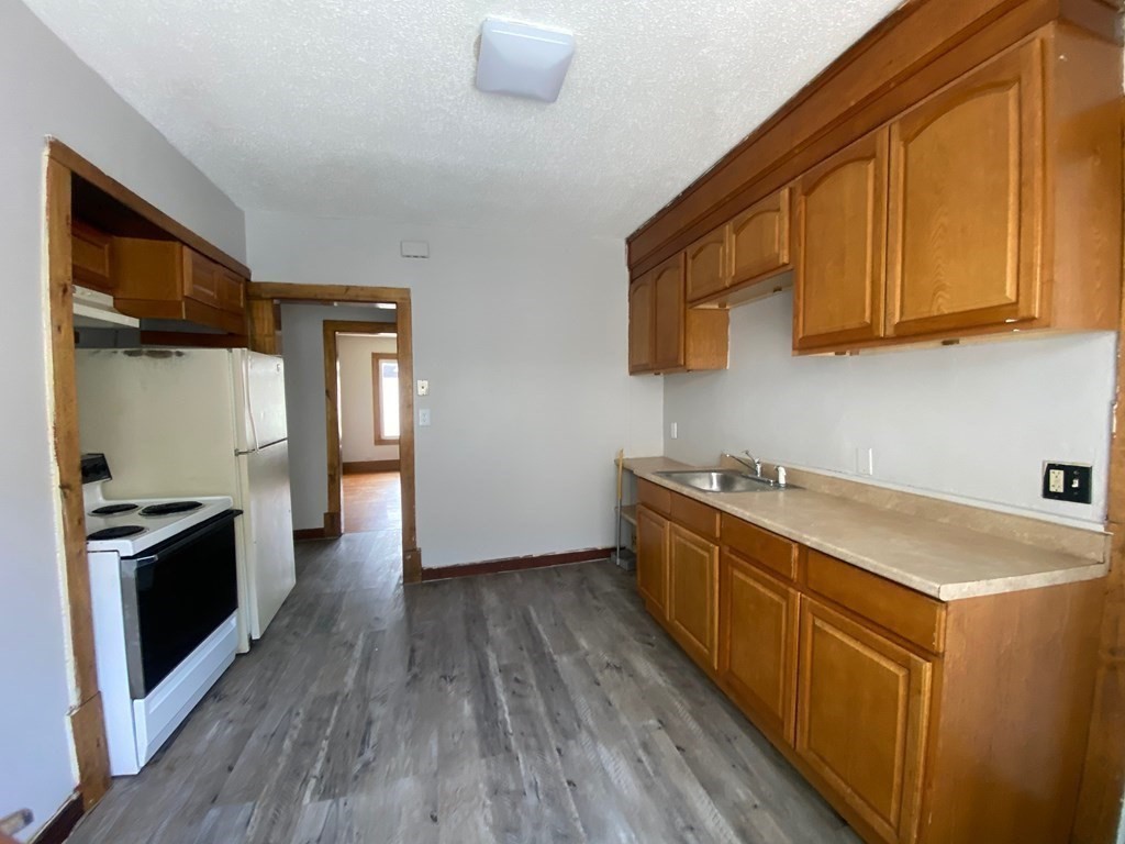 331-335 Allen Street Springfield, MA 01108 - Photo 2 of 8 a kitchen with stainless steel appliances granite countertop a stove a sink and a refrigerator